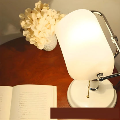 NXUS An antique traditional retro bankers desk lamp with a glass shade for use in living rooms, offices, meetings, and study spaces